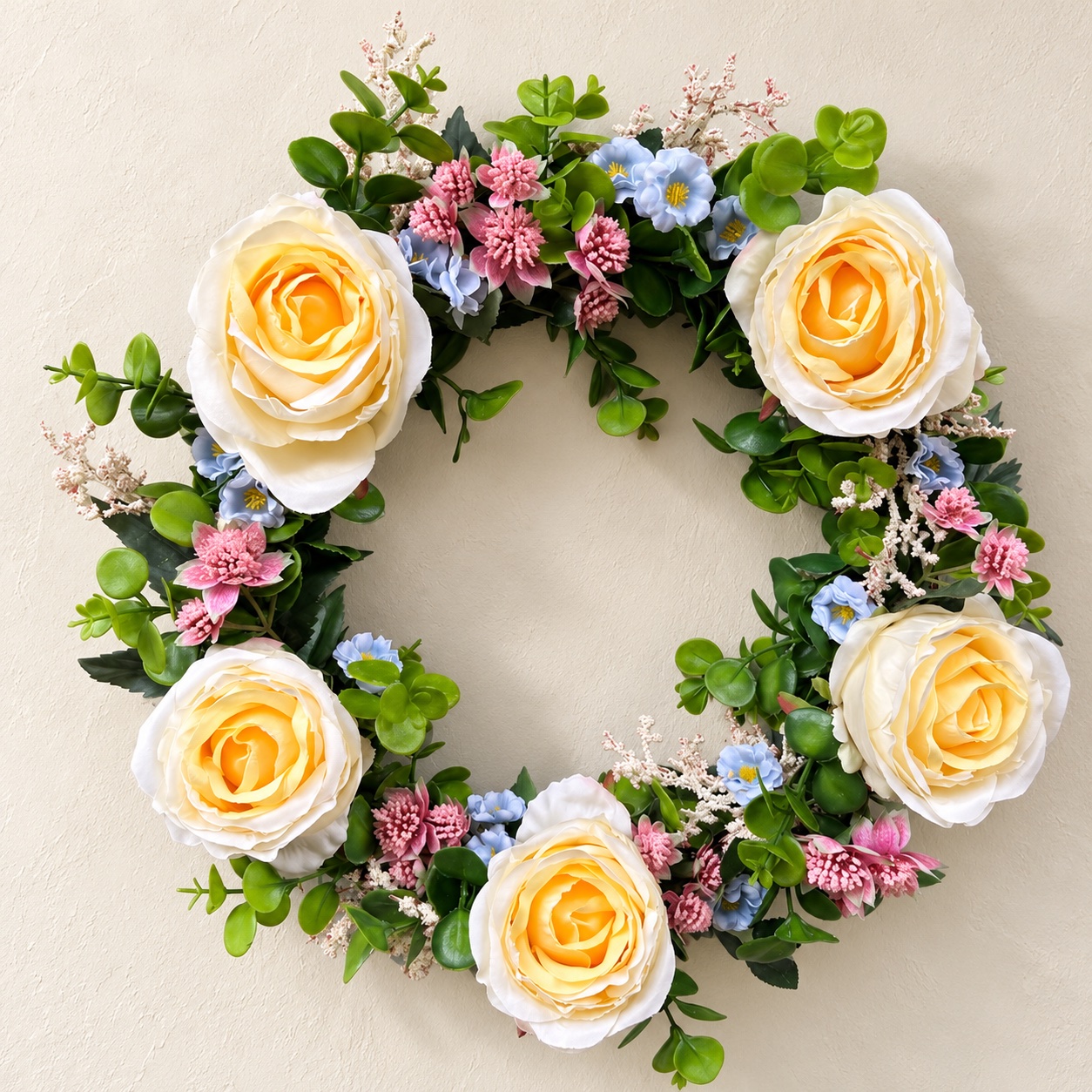 Our yellow rose wreath styled against a plain ivory plaster wall